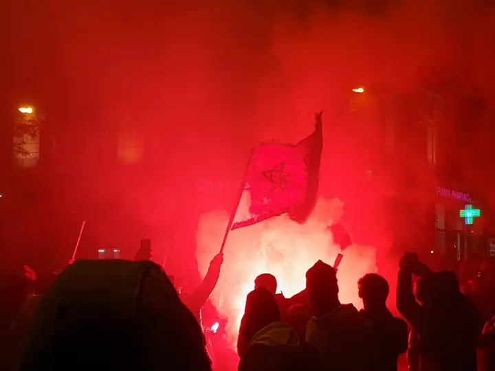 Moroccan football supporters celebrating, evoking Morocco's disputed status as AFCON's most recent champion heading into the 2027 tournament in East Africa