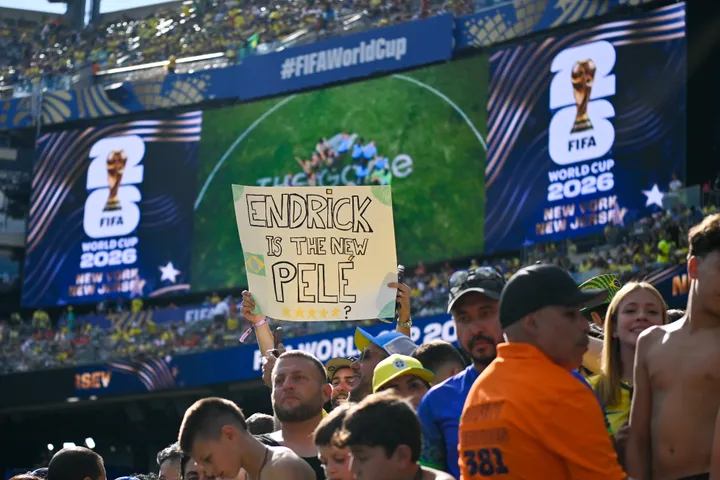 Supporters fill a packed stadium under official 2026 FIFA World Cup screens as the title odds tighten with eight teams left in the bracket